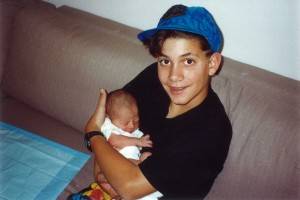 Ryan has always loved babies & children...here he is with his niece, Elise, when he was just a child himself.